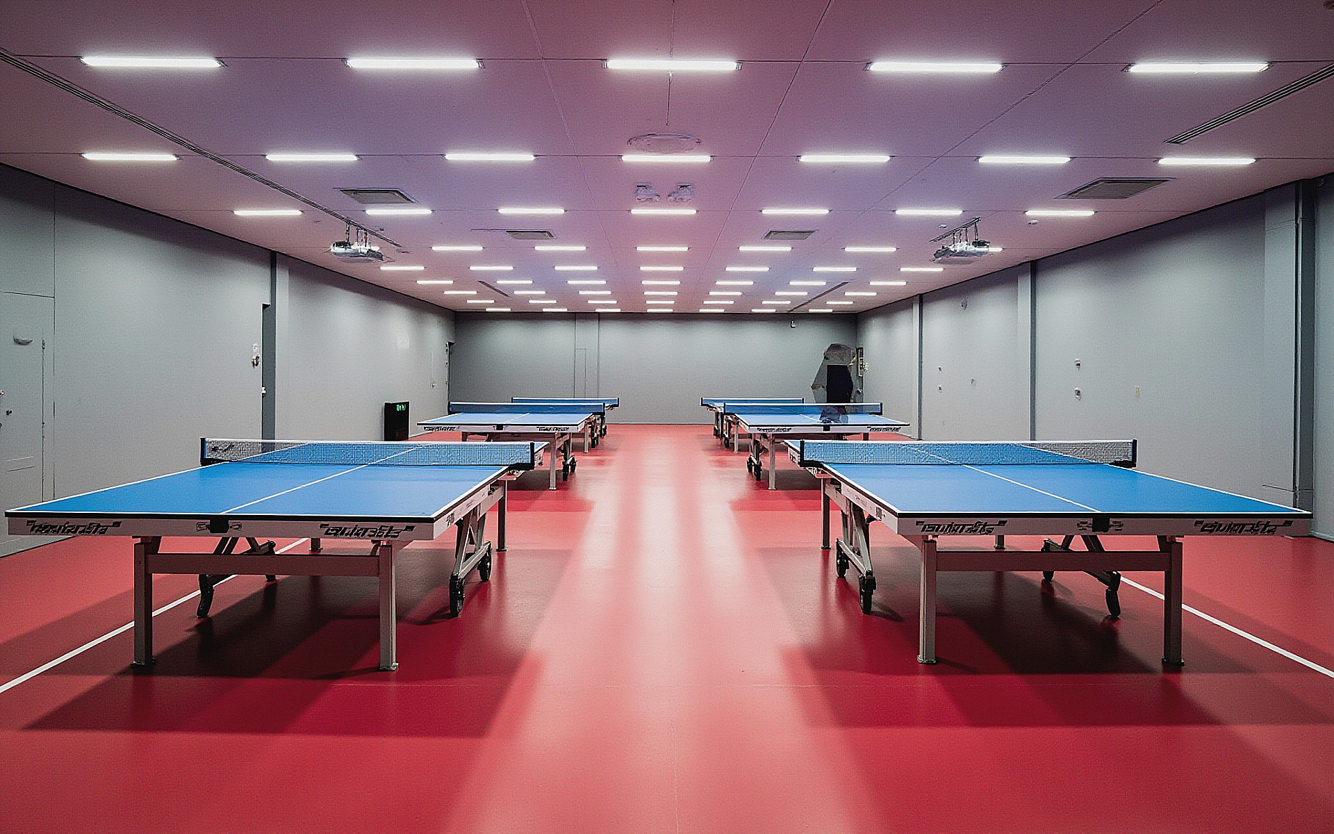 CTTC permanent training hall with rows of competition tables and red sport flooring